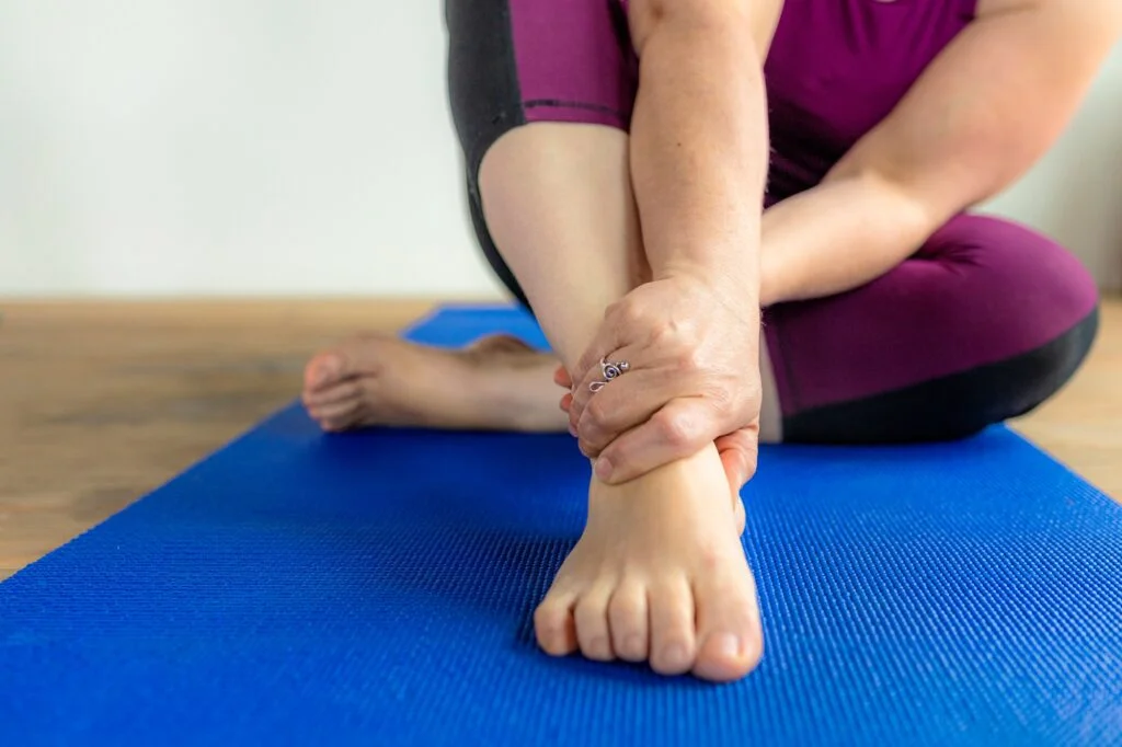 Woman holding her ankle