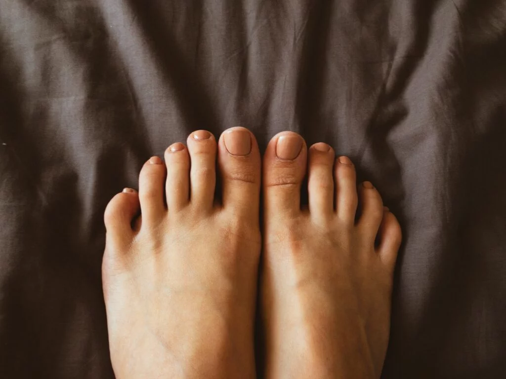 Feet over a black sheet