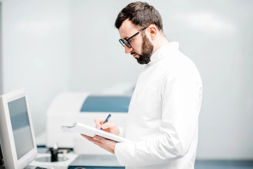 Doctor writing on a clipboard