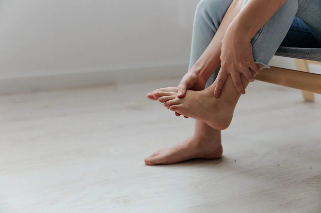 Person holding their foot