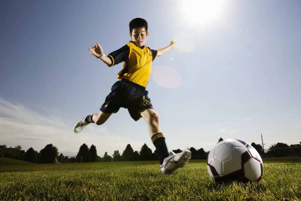 Kid preparing to kick a ball
