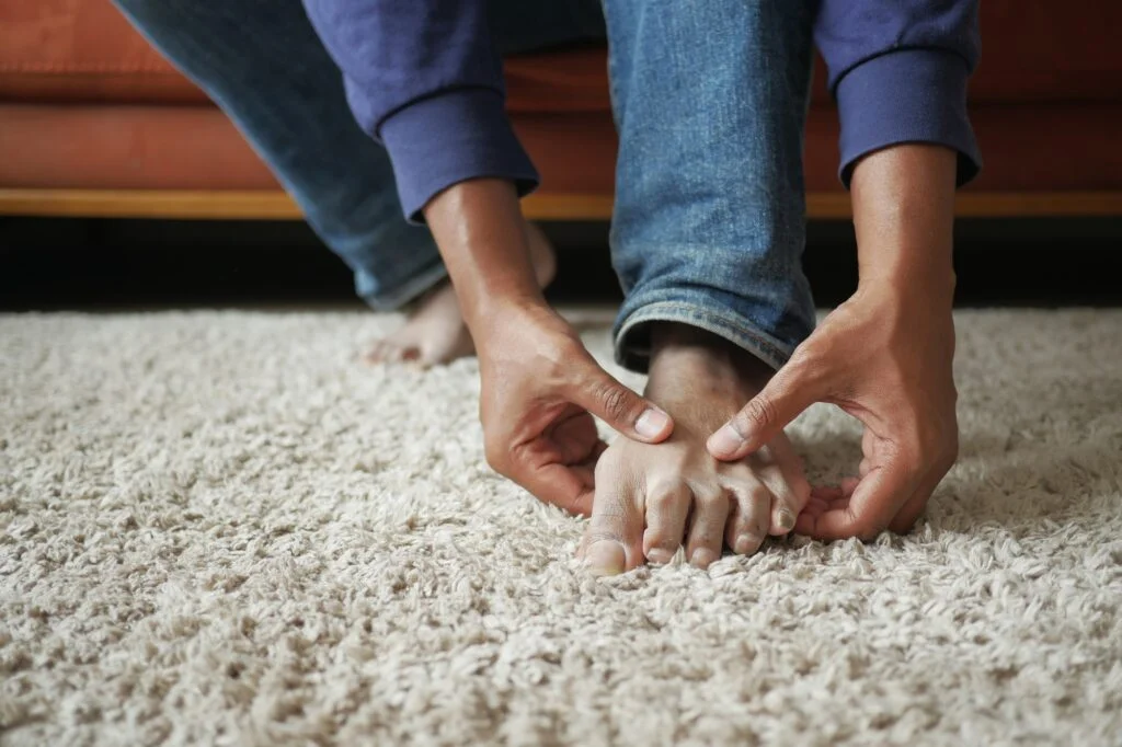 Person holding their foot