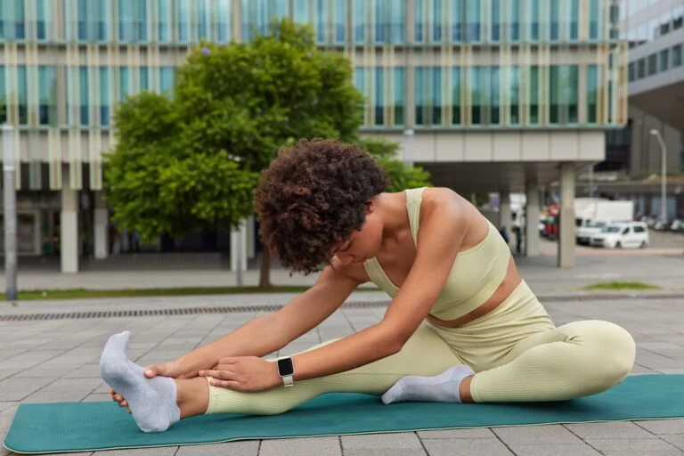 Woman doing stretching exercises to improve foot and ankle flexibility